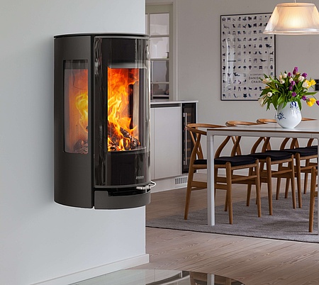 Wall-mounted stove with large glass door